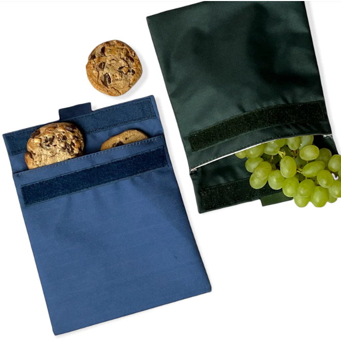 Reusable sandwich and snack bag. velcro closure and insulated interior. Durable material. Navy blue and fern green. wipe clean or throw in washing machine.