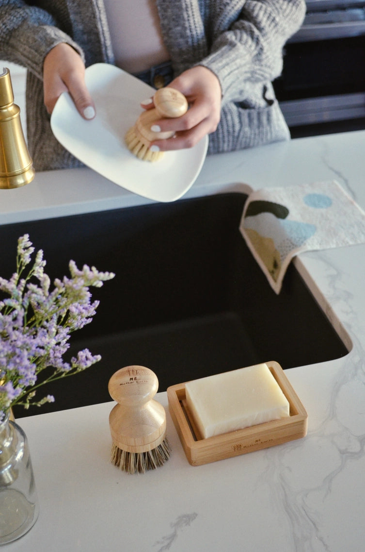 woman washing a dish with modular ergonomic hand brush