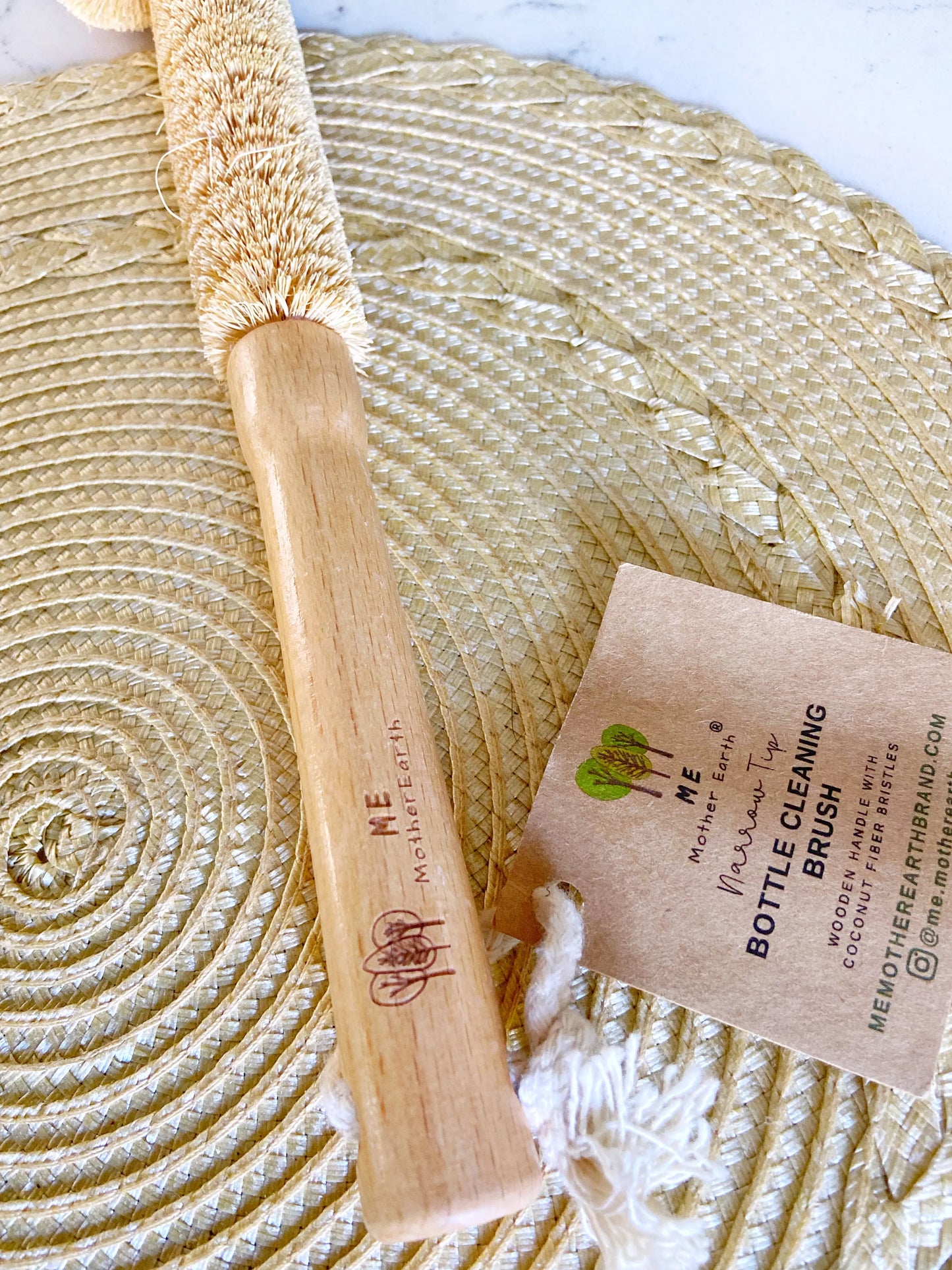 Bamboo handle of bottle cleaning brush. On rattan matt