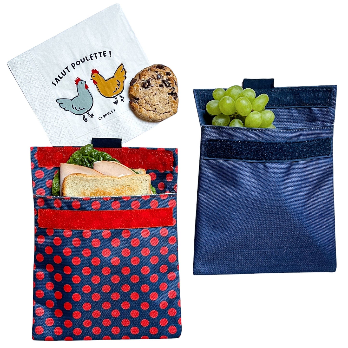 Reusable sandwich and snack bag.  velcro closure and insulated interior.  Durable material.  red polka dots on dark blue background.  wipe clean or throw in washing machine.