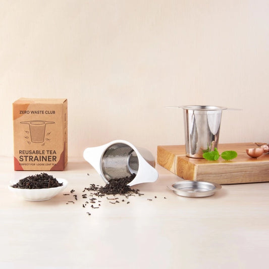reusable stainless steel tea strainer infuser with fine mesh shown with loose leaf tea and shopping block
