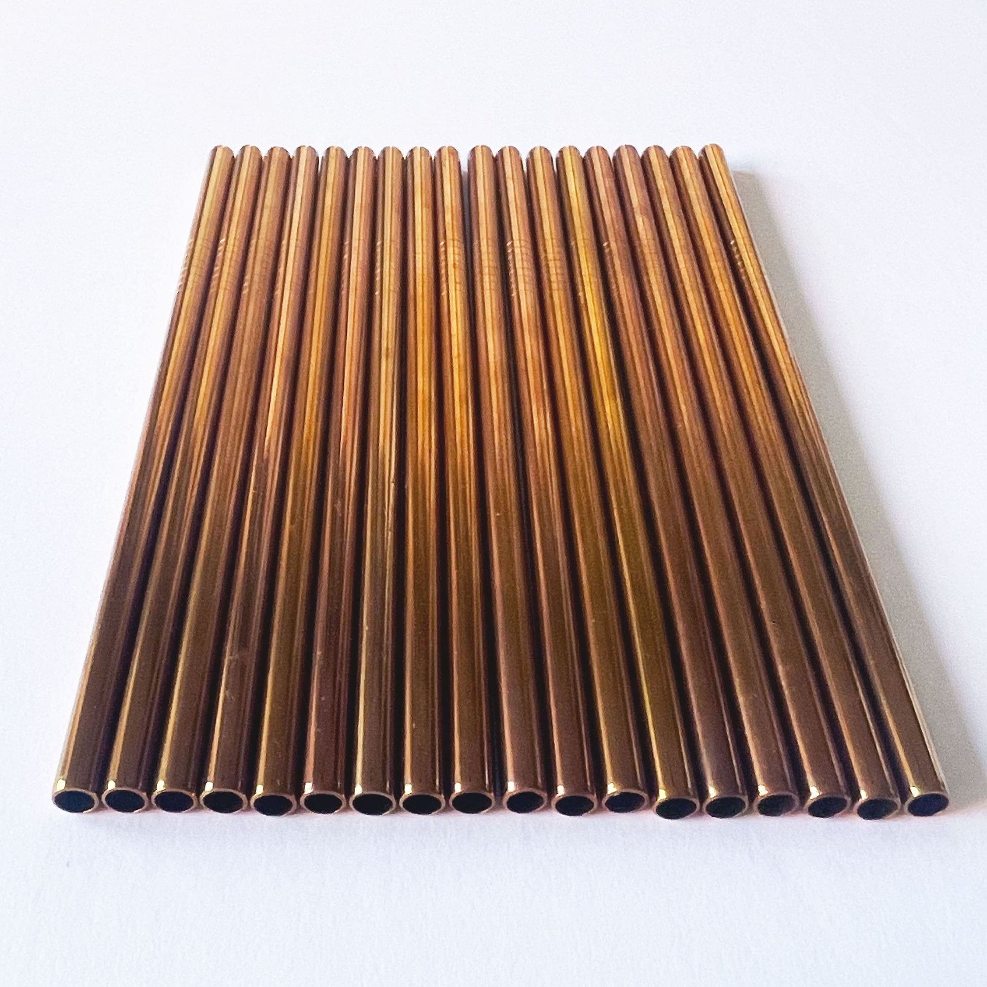 Collection of rose gold metal finish stainless steel straws and cleaner. 8mm wide, for smoothies