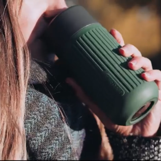 Woman sipping olive travel cup