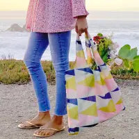 Woman carrying colorful reusable shopper